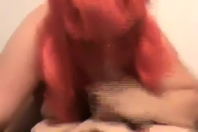 My busty mature wife wearing a red wig and blowing my jock